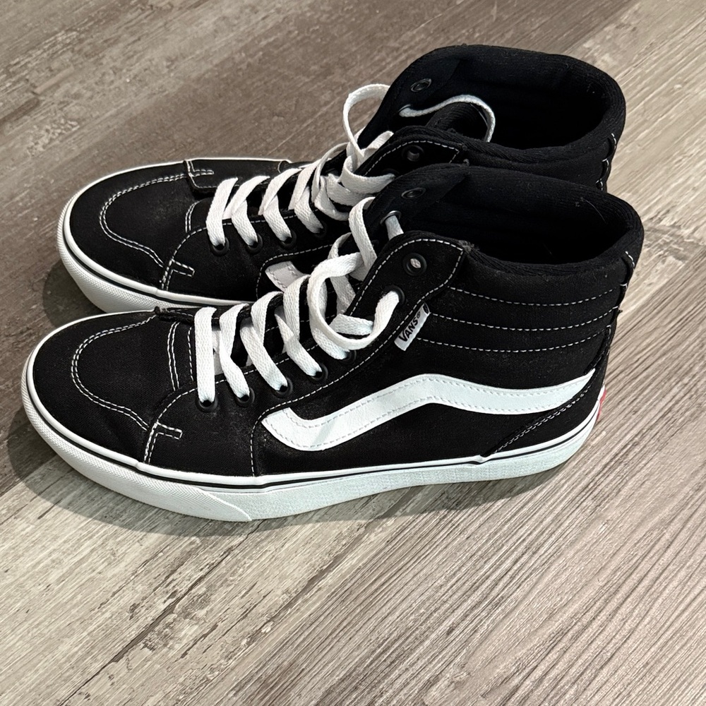 Vans women’s Black and White High-Top Sneakers